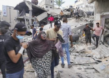 Palestinians evacuate survivors after the Israeli bombardment of the Gaza Strip in Deir Al-Balah, Sunday, Oct. 22, 2023. (AP Photo/Hatem Moussa)