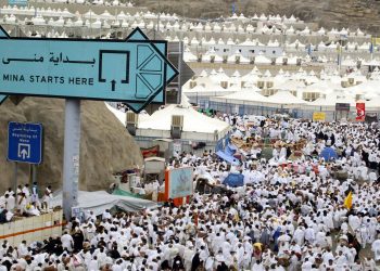 MECCA, SAUDI ARABIA:  Muslim pilgrims arrive to take part in the "Stoning of Satan" ritual of the annual hajj pilgrimage at one of the "jamarat", or three pillars symbolising the devil, 20 January 2005 in Mina, near Mecca. According to tradition, it is the place where Satan appeared first to Abraham, to his son, Ishmael, and to Ishmael's mother Hagar. All three pillars are to be stoned as the ritual resumes on Friday and Saturday, as the Islamic world marked the Eid al-Adha feast of sacrifice. AFP PHOTO/KARIM SAHIB   (Photo credit should read KARIM SAHIB/AFP/Getty Images)